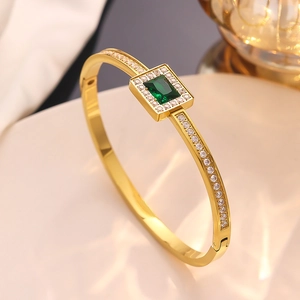 Luxurious gold stainless steel cuff bracelet with emerald green zircon and diamond accents