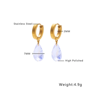 Detailed view of polished stainless steel drop earrings with faceted crystal pendants