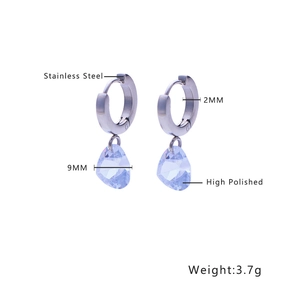 Macro detail of high polished stainless steel earrings with purple drop stones