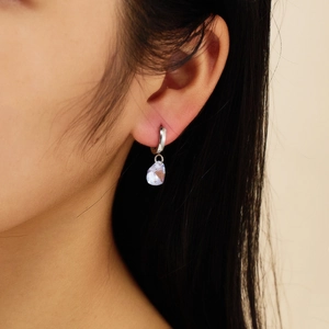 Close-up of model wearing water-drop lavender gemstone earrings in silver finish
