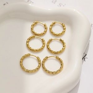 Three pairs of vintage gold titanium steel hoop earrings with textured diamond and rope patterns