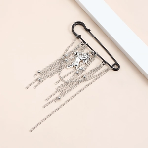 Fashionable horse year brooch with silver metallic tassels and dragon pendant on black pin