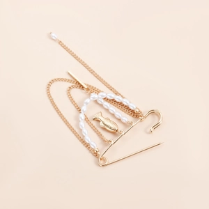Détail de la broche vintage dorée à chaînes multiples avec perles et pendentif poisson