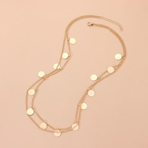 Elegant gold-tone layered chain necklace featuring shimmering round sequin charms