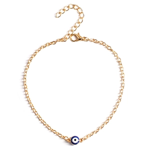 Golden Turkish Evil Eye charm bracelet with adjustable chain and lobster clasp on white