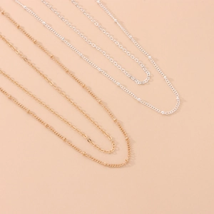 Minimalist gold and silver layered belly body chain with evil eye beads for women