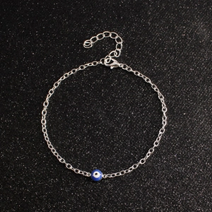 Detailed shot of silver evil eye bracelet with blue bead and adjustable lobster clasp