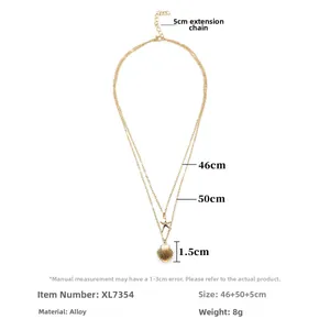 Layered gold necklace with starfish and seashell pendants on a clean white background