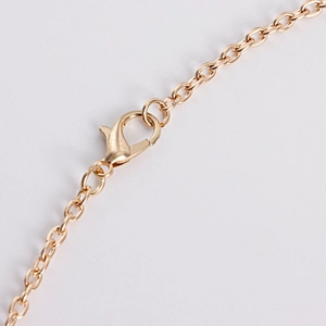 Close-up of golden alloy lobster clasp and fine chain links of the star headpiece