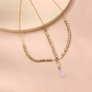Bohemian gold chain headpiece with geometric beads and pink teardrop gemstone pendant