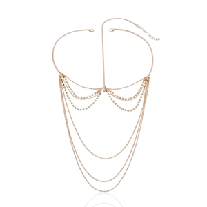 Detail of bohemian gold layered chain hair accessory with sparkling rhinestone accents