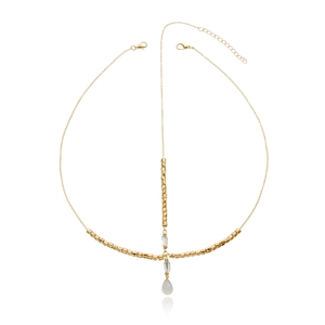 Detailed close-up of golden head chain with multifaceted beads and teardrop pendant