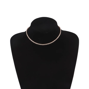 Detailed close-up of a double layer gold choker necklace with white crystal rhinestones