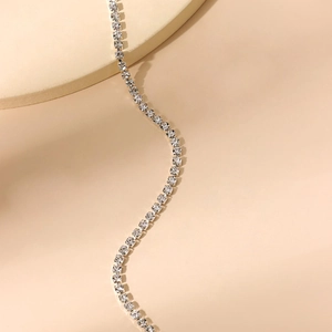Double-layered silver tennis chain necklace with sparkling cubic zirconia on beige base