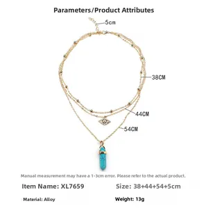 Three-layer gold-tone necklace featuring evil eye charm and turquoise crystal pillar pendant