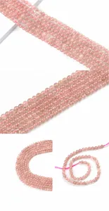Macro shot of 6mm natural strawberry quartz round beads with translucent mineral inclusions