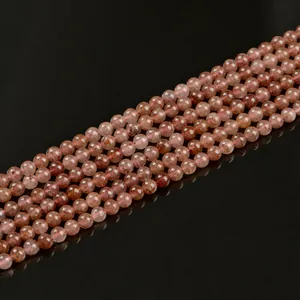 Polished 6mm strawberry quartz beads strings with natural pink minerals on black background