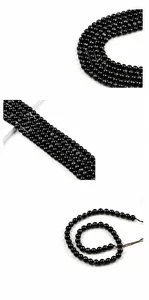 Macro detail of 8mm polished black tiger eye stone round beads with high gloss