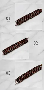 Macro shot of faceted red tiger eye stone beads showing natural texture and deep red tones