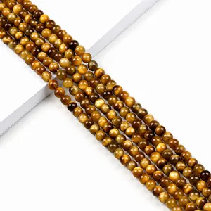 Perles rondes en oeil de tigre jaune de 6mm avec effet oeil de chat naturel sur fond blanc