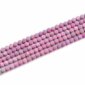 Macro detail of lavender lava stone beads showing natural porous texture and matte finish