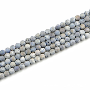 Macro detail of 8mm matte grey-blue natural stone beads for DIY jewelry making