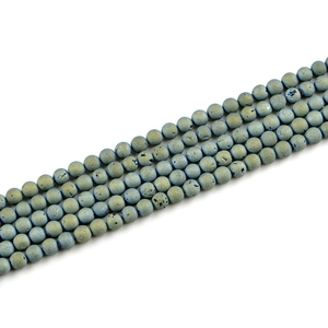 Macro detail of 8mm blue druzy stone beads with natural mineral crystal texture