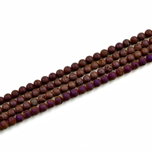 Macro view of 8mm lava stone beads with porous texture and deep reddish-brown tones
