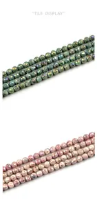 Close-up of faceted 10mm agate beads in green and purple with metallic luster