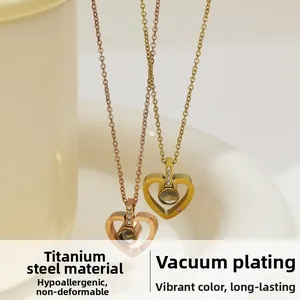 Detailed macro view of heart pendant necklaces in rose gold and gold titanium steel plating