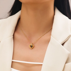 Golden heart necklace with 100 languages I Love You projection stone worn by model