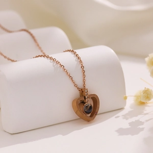 Detail of rose gold heart pendant with projection stone and micro-inlaid diamonds