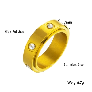 Detailed macro view of 7mm high polished gold spinner ring with sparkling zircon inlay