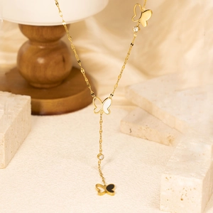 Elegant gold butterfly Y-shaped necklace with black and white shell inlays on stone