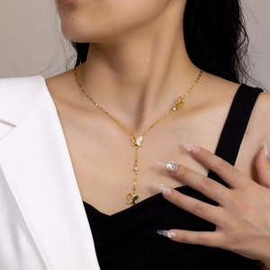 Golden Y-shaped necklace with white shell, hollow butterfly charms and crystal accents