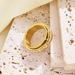 Detail of a spinning golden stainless steel ring with micro-pave cubic zirconia stones