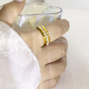 Elegant gold spinning ring with full pavé cubic zirconia worn by hand with lace cuff