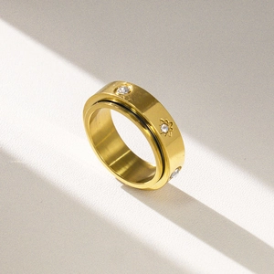 Golden stainless steel spinner ring with sparkling zircons and engraved stars on band