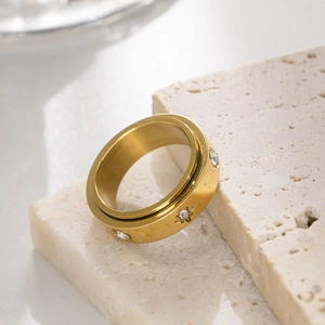 Detailed macro view of the gold starburst engraved ring with sparkling cubic zirconia stones