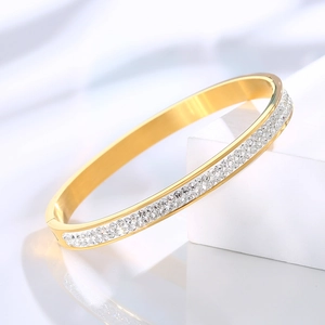 Close-up of gold-plated titanium steel bracelet with double row of cubic zirconia stones