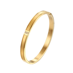 Detail view of 18K gold plated stainless steel bangle with three sparkling zircons