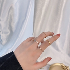 Set of five minimalist 18k gold silver and rose gold stainless steel rings on hand