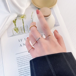 Minimalist 18k gold and silver stainless steel rings on hand for a stackable look