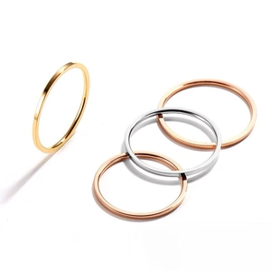 Detailed view of minimalist 18k gold silver and rose gold polished stackable steel rings
