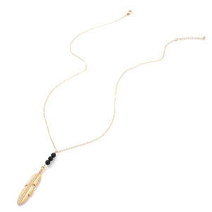 Bohemian gold feather pendant necklace with black volcanic stone beads on white background