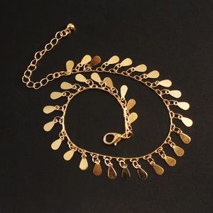 Detail of golden teardrop anklet with lobster clasp and adjustable extension chain