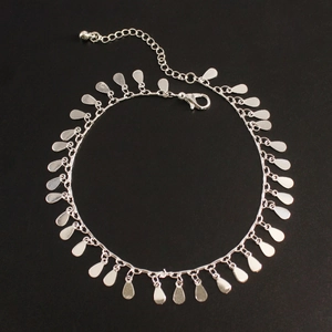 Detailed view of silver water drop charms on a minimalist beach anklet with lobster clasp