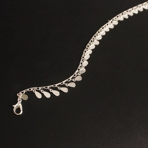 Detailed view of silver water drop sequins on a beach anklet with lobster clasp closure