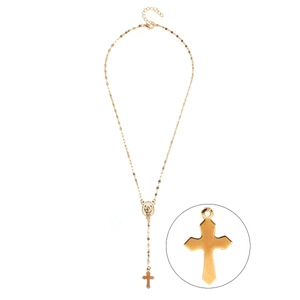 Close-up of golden religious necklace with cross pendant and virgin mary medallion detail