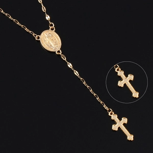 Detail view showing golden rosary necklace with Mary medal, cross pendant and macro zoom
